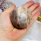 Shimmering Sunstone with Moonstone Sphere on Stand 250g