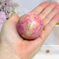 Thulite Sphere with Epidote 199g On Stand
