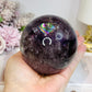 Large High Grade Phantom Amethyst Sphere with Rainbows On Stand 665g