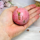 Thulite Sphere with Epidote 214g On Stand